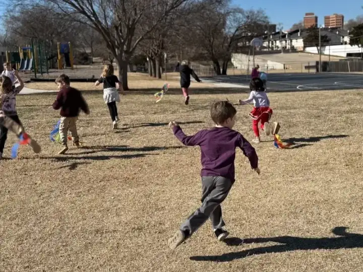 Children flying a kite together